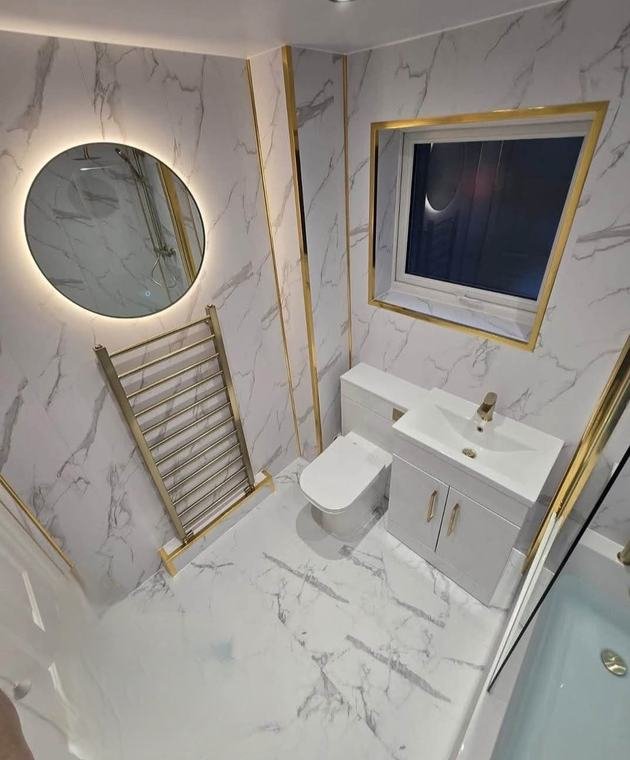 Marble-effect bathroom with gold trims and LED mirror