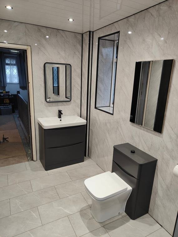 Black vanity and wall-hung toilet
