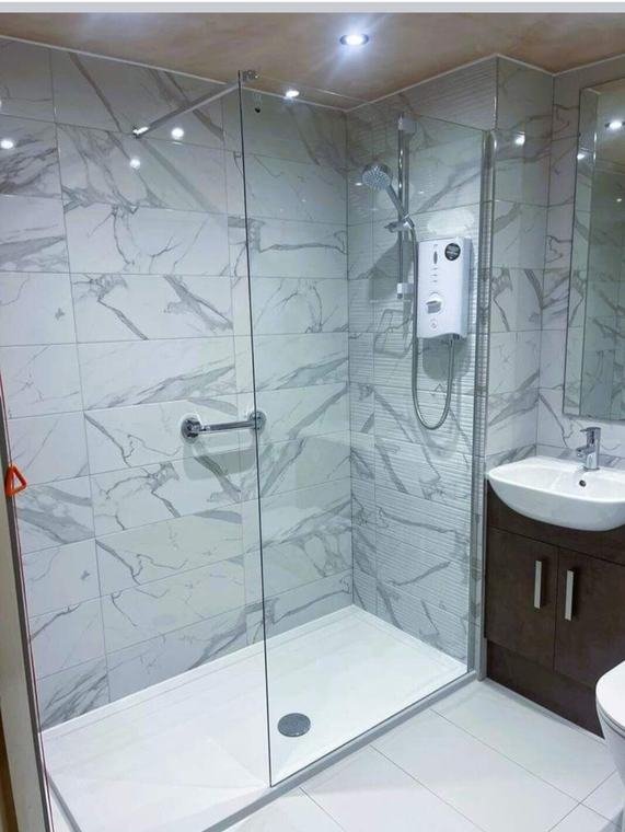 Shower enclosure with electric shower
