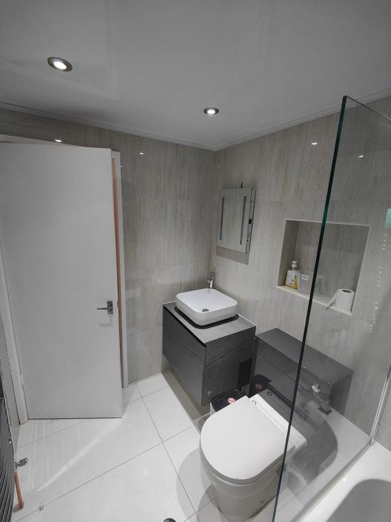 Grey bathroom with vessel basin and niche