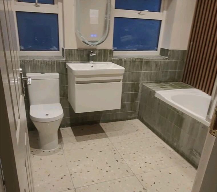 Terrazzo-effect floor, wall-hung basin and LED mirror