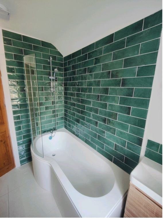 Green metro tiles around a P-shaped bath
