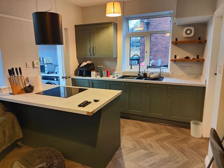 Sage shaker kitchen with island and herringbone floor