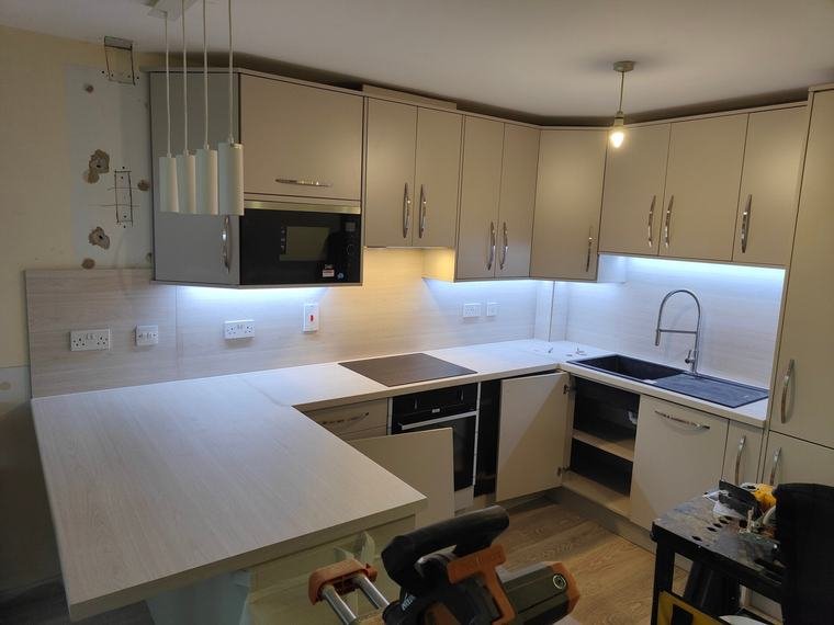 Pale grey kitchen with LED strips