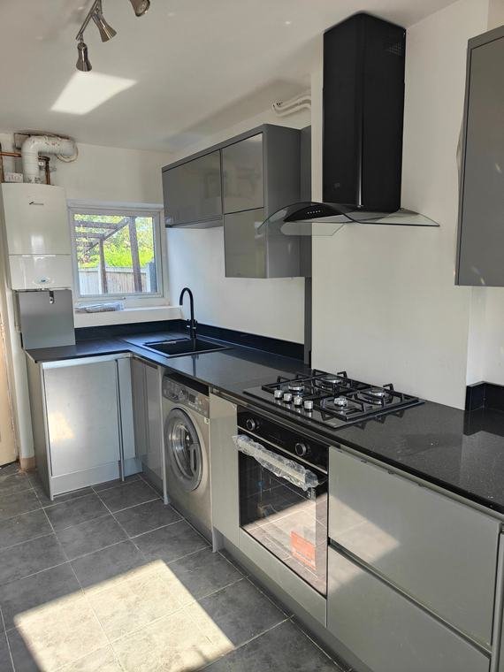 White kitchen with black worktops