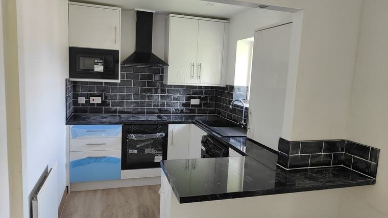 White gloss units with black worktops