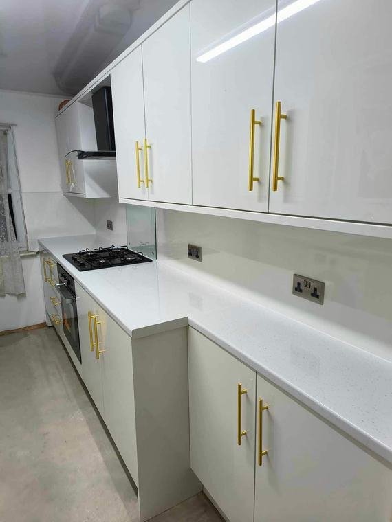 White gloss kitchen with brushed-gold handles